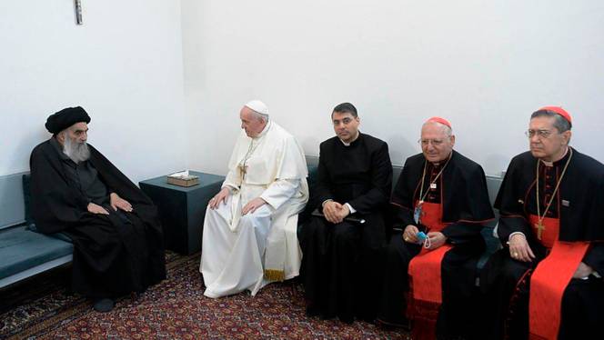 A photo released by the Grand Ayatollah Ali al Sistani Office shows Shia Muslim leader, Grand Ayatollah Ali al Sistani, left, meeting Pope Francis, 2nd left, along with Christian priests in Najaf, Iraq, March 6, 2021.