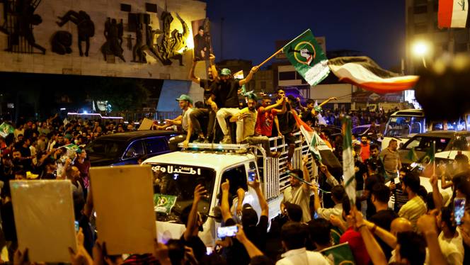 Iraqi supporters of Sadr's movement celebrate after preliminary results of Iraq's parliamentary election were announced in Baghdad, Iraq on October 11, 2021.