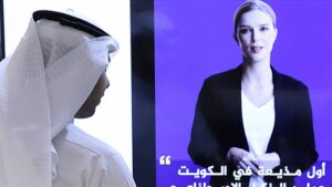 A journalist watches an introductory video by the 'artificial intelligence anchor Fedha on the Twitter account of Kuwait News service