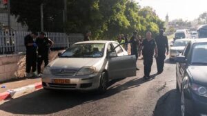 Israeli police work next to the car at the scene of a shooting incident in East Jerusalem.