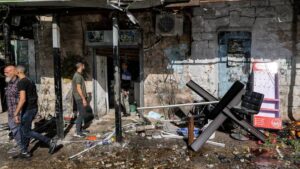 People gather outside a ransacked building following an Israeli military incursion at Jenin camp for Palestinian refugees in the occupied West Bank.
