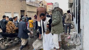 Residents of Sanaa gather on Thursday outside the site of a stampede late on Wednesday.