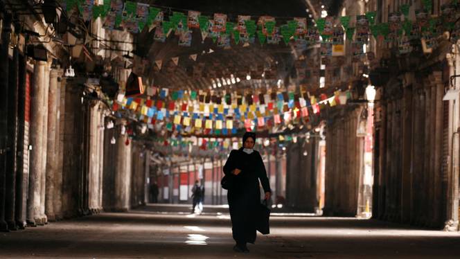 A woman walks in empty Souk al Hamidieh as restrictions are imposed to prevent the spread of the coronavirus disease (Covid-19) in Damascus, Syria, March 24, 2020.