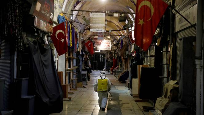 A worker in a protective suit sprays disinfectant at Grand Bazaar, known as the Covered Bazaar, to prevent the spread of coronavirus disease (COVID-19), in Istanbul, Turkey, March 25, 2020.