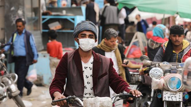 A man wears a protective face mask as he rides a motorcycle amid fears of the spread of the coronavirus disease (COVID-19) in Sanaa, Yemen March 16, 2020.