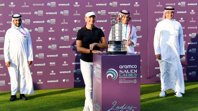 Danish golfer Emily Kristine Pedersen (C) poses next to the trophy after winning the Saudi Ladies International golf tournament on November 15, 2020, at the King Abdullah Economic City, north of Jeddah.