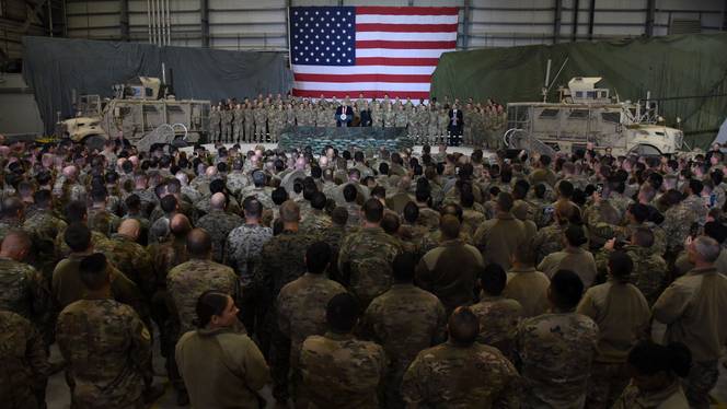 (FILES) In this file photo US President Donald Trump speaks to the troops during a surprise Thanksgiving day visit at Bagram Air Field, on November 28, 2019 in Afghanistan.