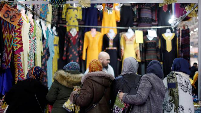 Visitors buy women's clothes during 35th annual cultural and festive event organised by Union of Islamic Organizations of France at Le Bourget, near Paris, France, March 30, 2018.