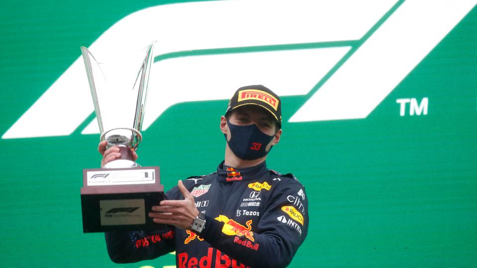 Red Bull's Max Verstappen celebrates his first place in Belgian Grand Prix, Spa-Francorchamps, with trophy on the podium on August 29, 2021.