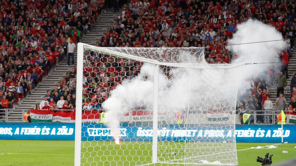 A flare is thrown onto the pitch during the World Cup 2022 group I qualifying football match between Hungary and England at the Ferenc Puskas stadium in Budapest, Hungary, September 2, 2021.