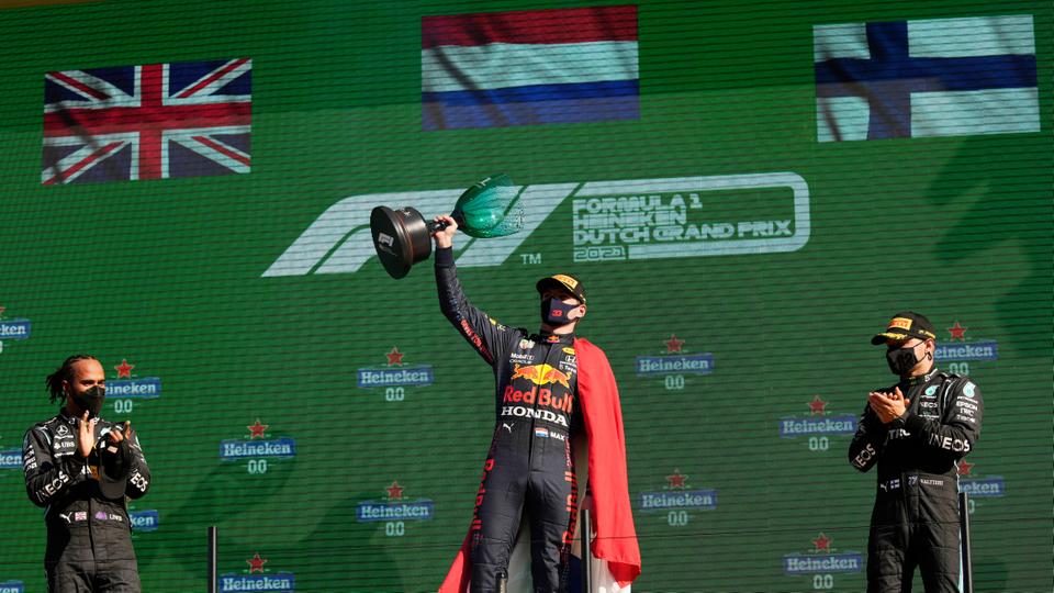 Red Bull's Max Verstappen celebrates on the podium with the trophy after winning Dutch Grand Prix taking Formula One championship lead in Zandvoort, Netherlands on September 5, 2021.