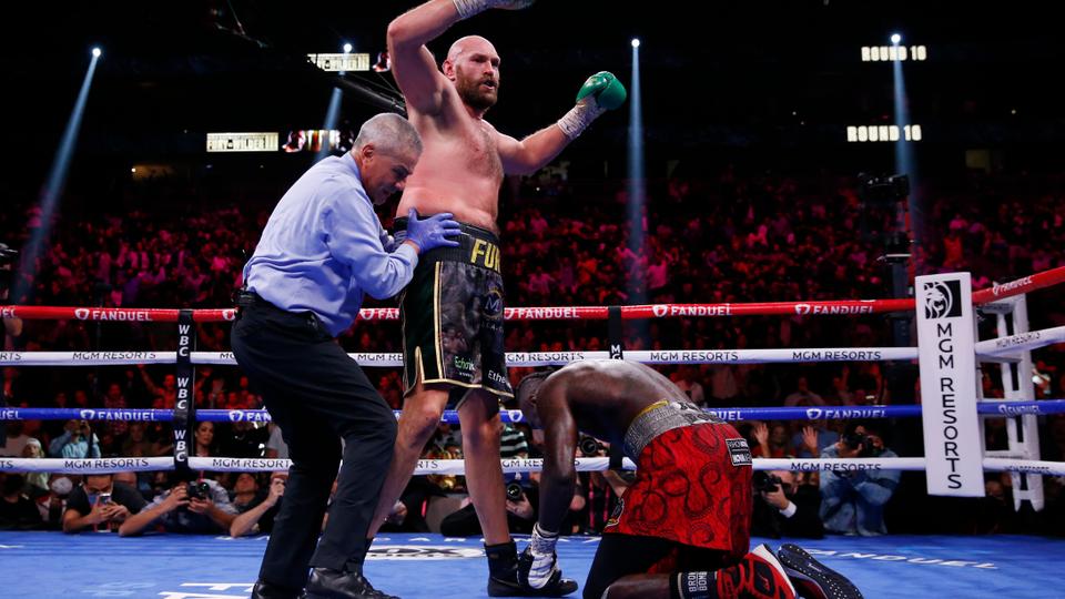 Tyson Fury, of England, knocks down Deontay Wilder in a heavyweight championship boxing match Saturday, Oct. 9, 2021, in Las Vegas.