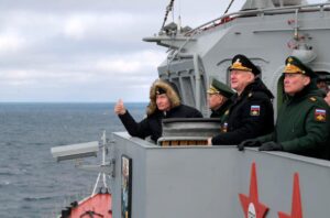 Commander of the Southern Military District troops Alexander Dvornikov, right, watch a navy exercise from the Marshal Ustinov missile cruiser in the Black Sea, Crimea, Jan. 9, 2020.