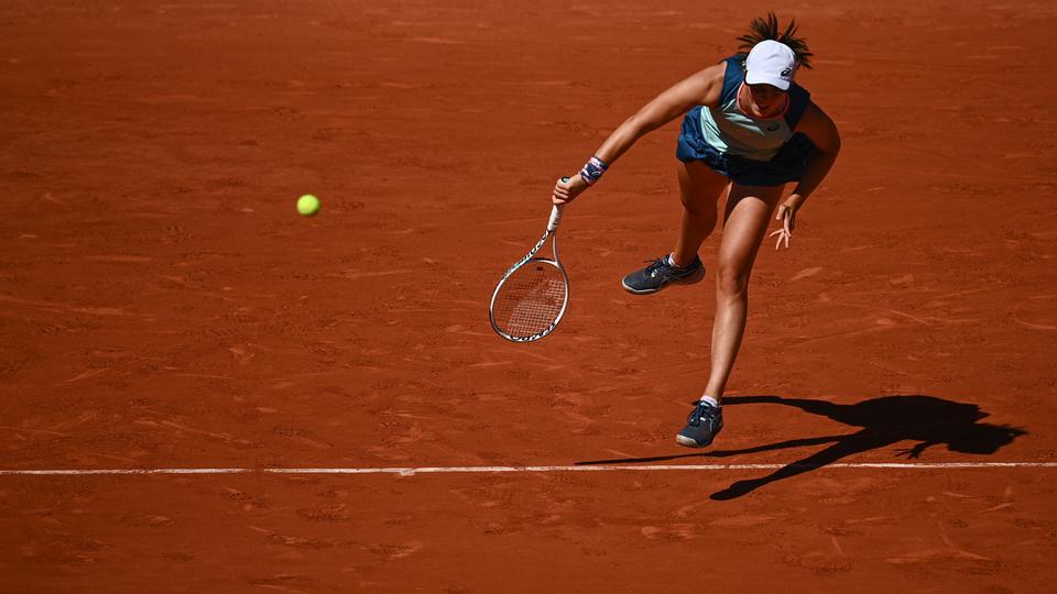 Swiatek serves to Russia's Darya Kasatkina during their women's semi-final singles match on day twelve of the Roland-Garros Open tennis tournament at the Court Philippe-Chatrier in Paris on June 2, 2022.