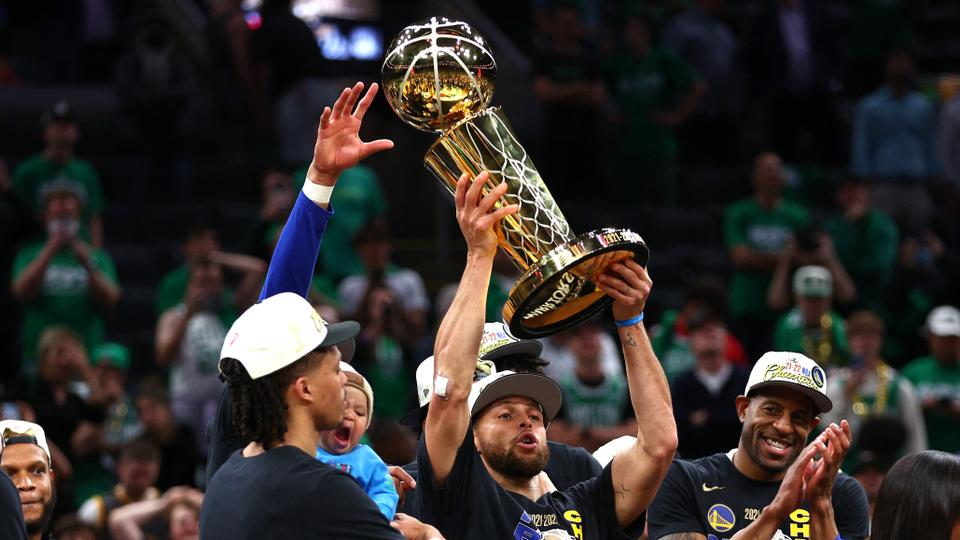Stephen Curry #30 of the Golden State Warriors raises the Larry O'Brien Championship Trophy after defeating the Boston Celtics 103-90 in Game Six of the 2022 NBA Finals at TD Garden on June 16, 2022 in Boston, Massachusetts.