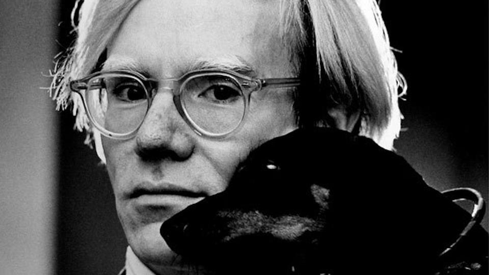 Andy Warhol with Archie, his pet dachshund.