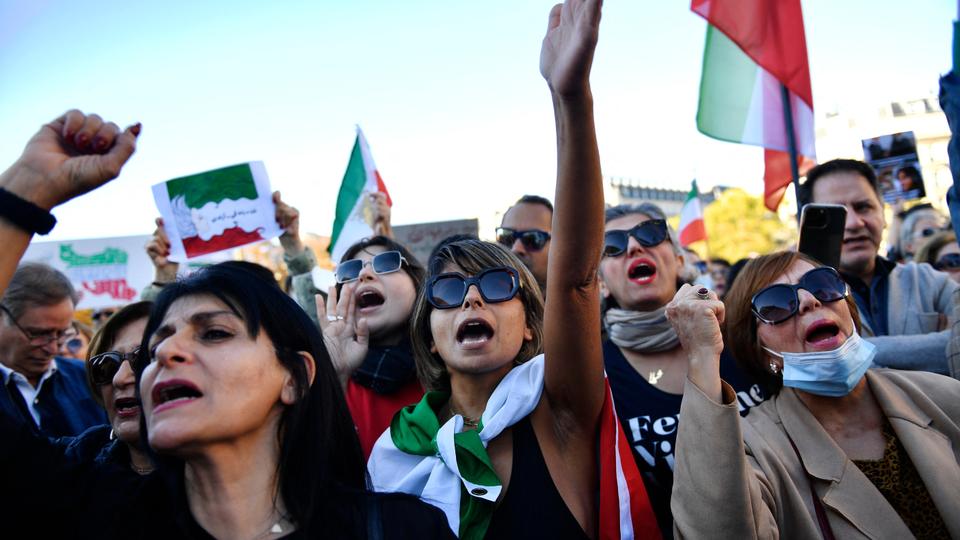 Demonstrators shout slogans during a rally in support of Iranian protests in Paris as demonstrations against 22-year-old Mahsa Amini's death spread beyond Iran's borders.