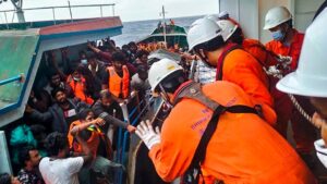 Crew members of the Japan-flagged 'Helios Leader' vessel also help with the rescue operation.