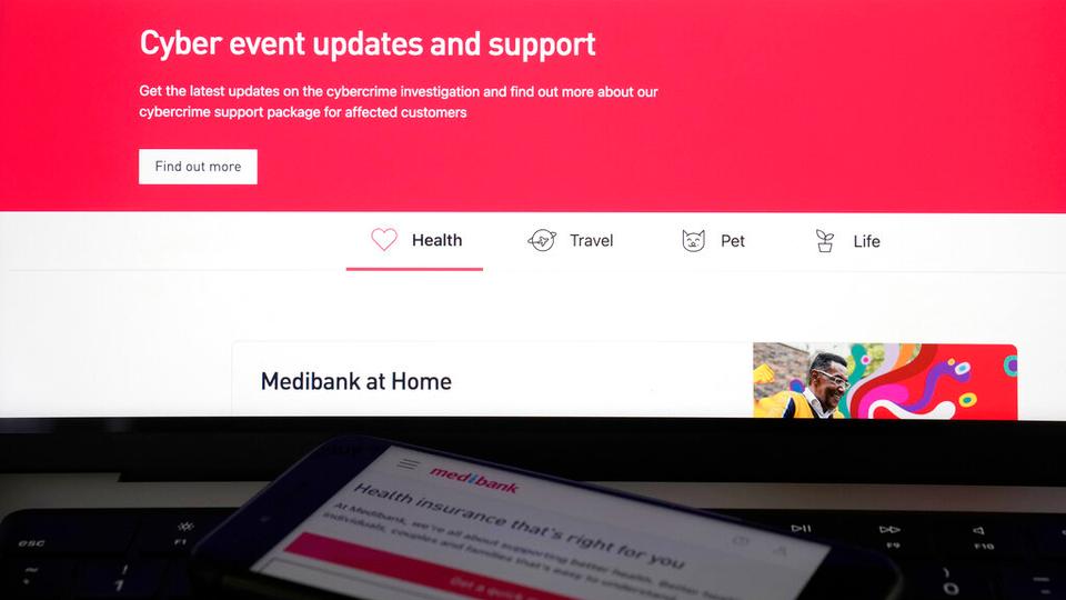 A computer and phone display pages from the Medibank Private website in Sydney.