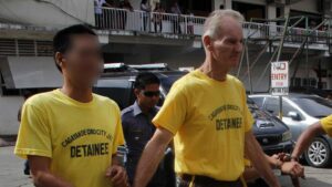 This file photo taken on June 16, 2015 shows Peter Scully of Australia (R), accused of raping and trafficking two girls in the Philippines.