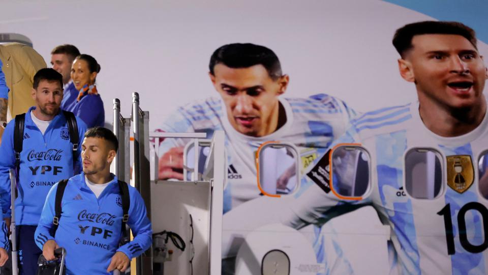 Argentina's forward Lionel Messi (L) and Argentina's midfielder Leandro Paredes arrive at the Hamad International Airport in Doha on November 17, 2022.