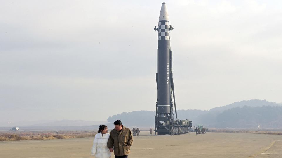 North Korean leader Kim Jong-un, along with his daughter, walks away from an intercontinental ballistic missile in this undated photo released on November 19, 2022, by KCNA.