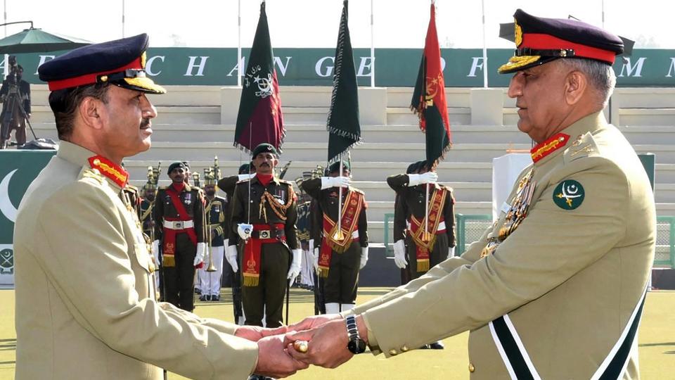 Pakistan's new Army Chief General Syed Asim Munir (L) receives change of command baton from outgoing army chief General Qamar Javed Bajwa (R) during change of command ceremony in Rawalpindi.