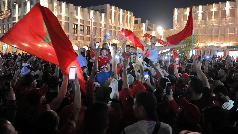 Jubilant Moroccans, Qataris, Saudis, Palestinians and others pour through historic alleys of Souq Waqif in central Doha after Morocco's win.