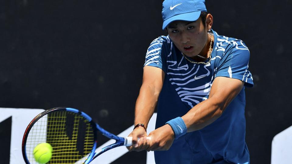 China's Shang Juncheng hits a return against Germany's Oscar Otte