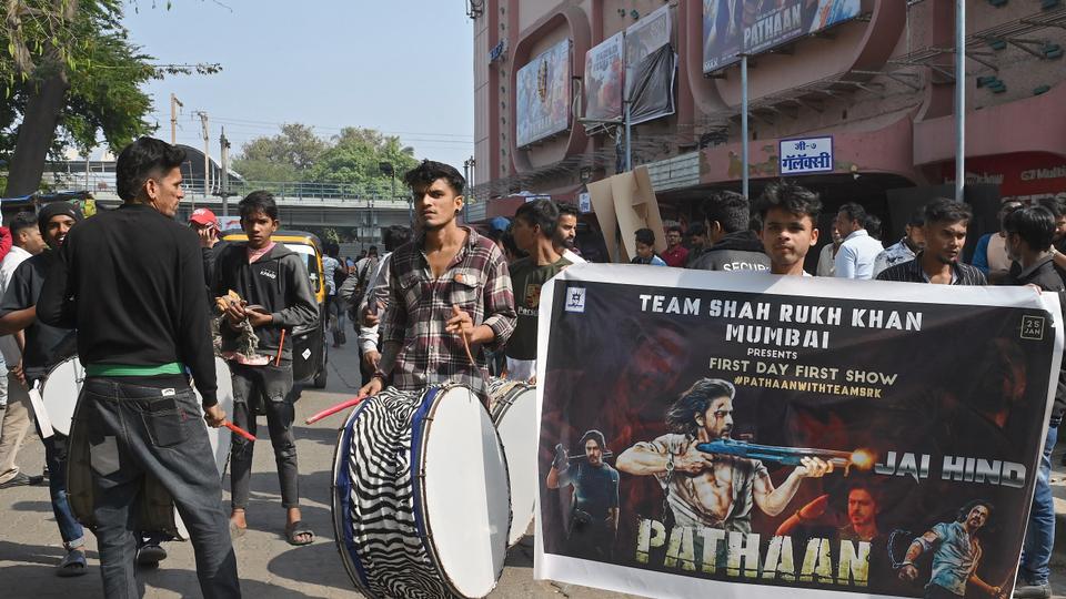 Fans of Bollywood actor Shah Rukh Khan gather outside a cinema hall to watch his movie 'Pathaan' in Mumbai.