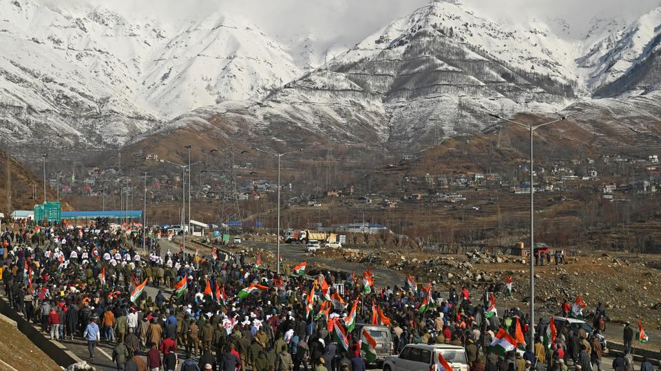People walk along Rahul Gandhi and ex-chief minister of region Omar Abdullah in Banihal area of India-administered Kashmir.