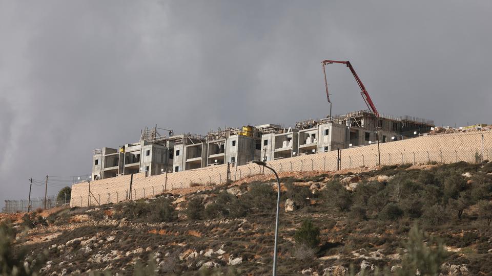 A picture taken from the Palestinian village of Qusra shows the ongoing construction of residential blocks at the Israeli settlement of Migdalim near Nablus in the occupied southern West Bank on January 30, 2023.