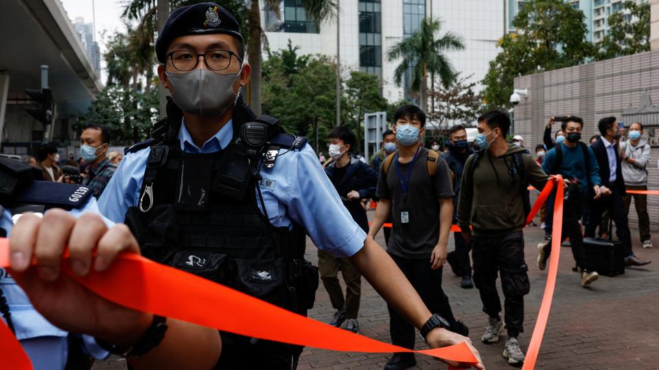 Police ask supporters to leave the entrance of West Kowloon Magistrates' Courts building during the hearing of the 47 pro-democracy activists charged with conspiracy to commit subversion under the national security law, in Hong Kong on Monday.