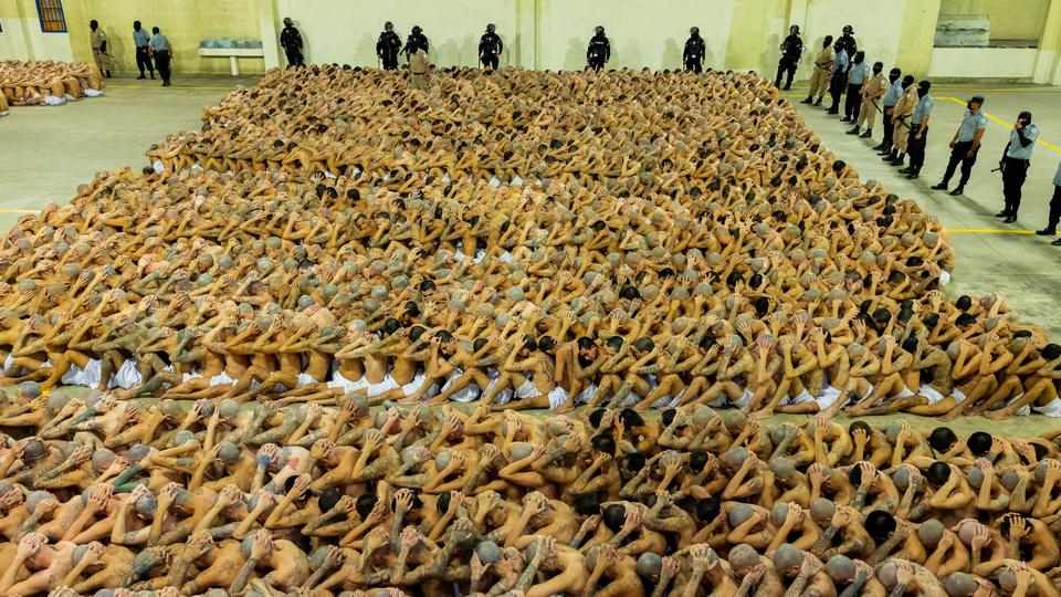 Inmates wait to be taken to their cells after 2000 suspected gang members were transferred to Terrorism Confinement Center.