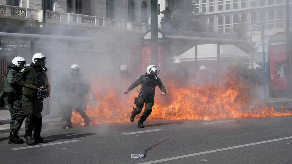 A petrol bomb explodes next to riot police during a demonstration, after a collision between two trains, near the city of Larissa, in Athens, Greece on March 05, 2023.