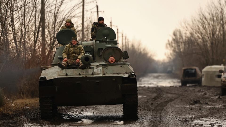 Ukrainian servicemen ride a 2C1 self-propelled howitzer along a road near the frontline town of Bakhmut in Donetsk region, Ukraine on March 8, 2023.