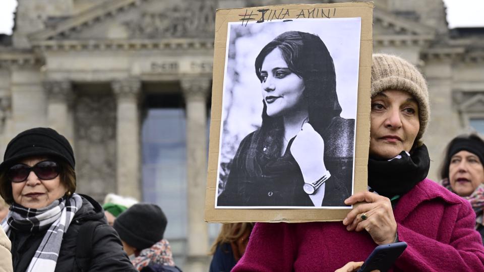 A woman holds a portrait of Mahsa Amini during a demonstration in front of the German lower house of parliament (Bundestag), on the occasion of International Women's Day, on March 8, 2023.