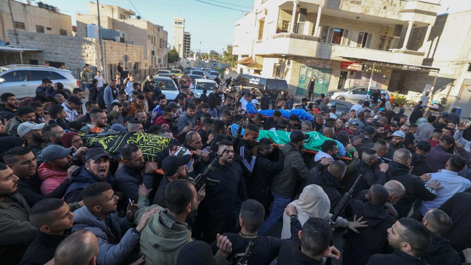 Mourners carry the bodies of Palestinians killed in an Israeli raid earlier in the day, during their funeral in Jenin city in the occupied West Bank, on March 16, 2023.