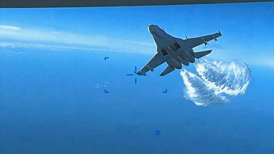 This photo taken from video released on Thursday, March 16, 2023, shows a Russian Su-27 approaching the back of the MQ-9 Reaper US Air Force UCAV drone.
