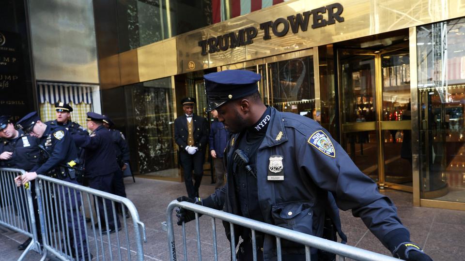 NYPD officers place metal barricades outside of Trump Tower on March 21, 2023.