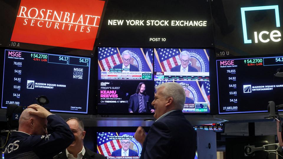 Traders react as Federal Reserve Chair Jerome Powell is seen delivering remarks on a screen, on the floor of the New York Stock Exchange (NYSE) in New York City, US, March 22, 2023.