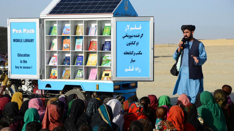 Wesa (standing) insists that his work was free of political interference and impartial and his focus was on helping communities encourage girls' education.