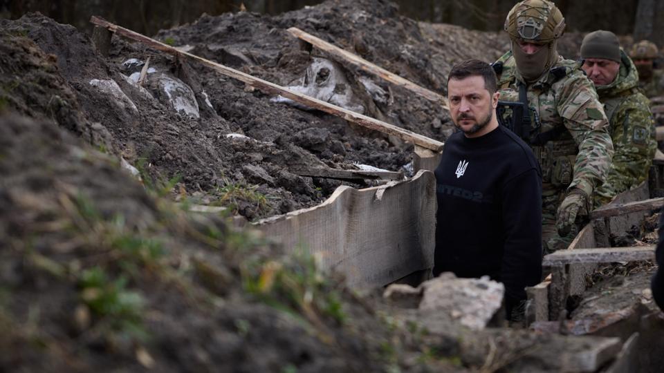 President Volodymyr Zelenskyy walks along tranches with border guard officers as he inspects the state border with Russia in Sumy region.