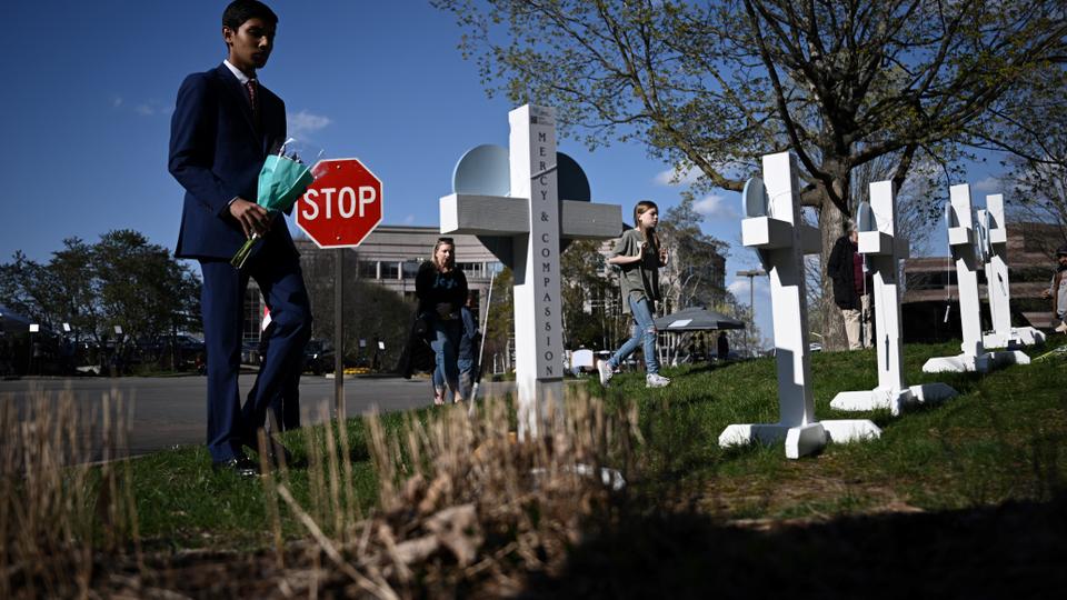 People pay their respects at a makeshift memorial for victims at the Covenant School building at the Covenant Presbyterian Church following shooting in Nashville.