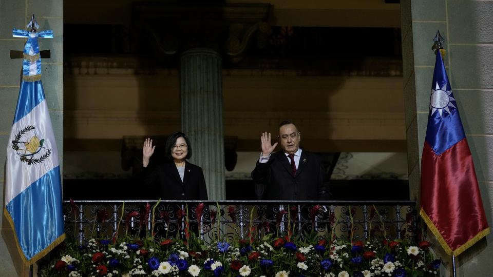 Taiwan's Tsai Ing-wen [L] and Guatemala's President Alejandro Giammattei wave from a balcony at National Palace in Guatemala City.