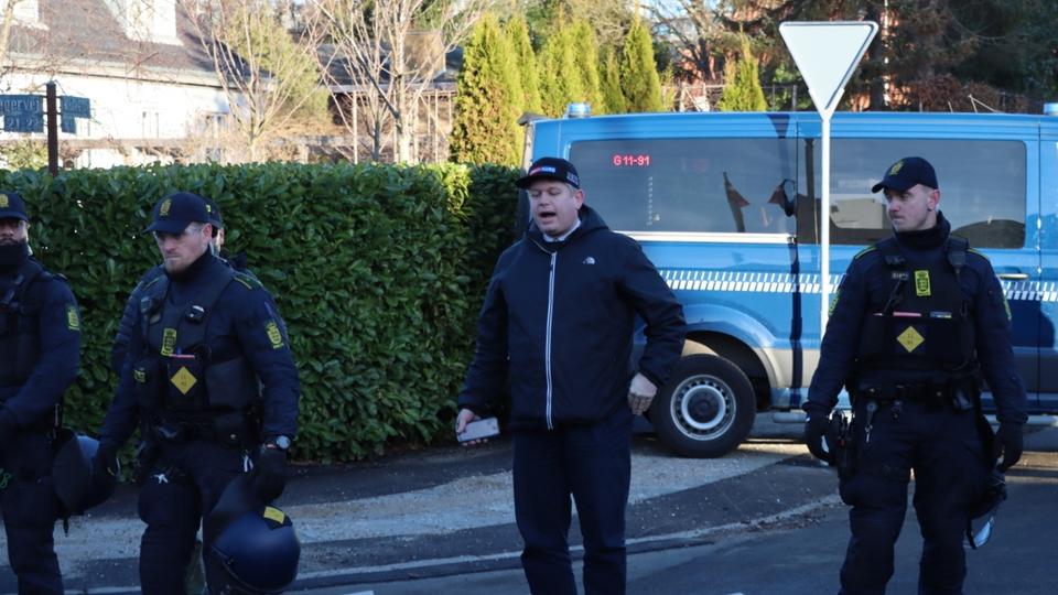 Rasmus Paludan, a far-right Danish politician is being protected by Danish policemen as he makes a statement before burning a copy of the Quran in front of Turkish Embassy in Copenhagen, Denmark on January 27, 2022.