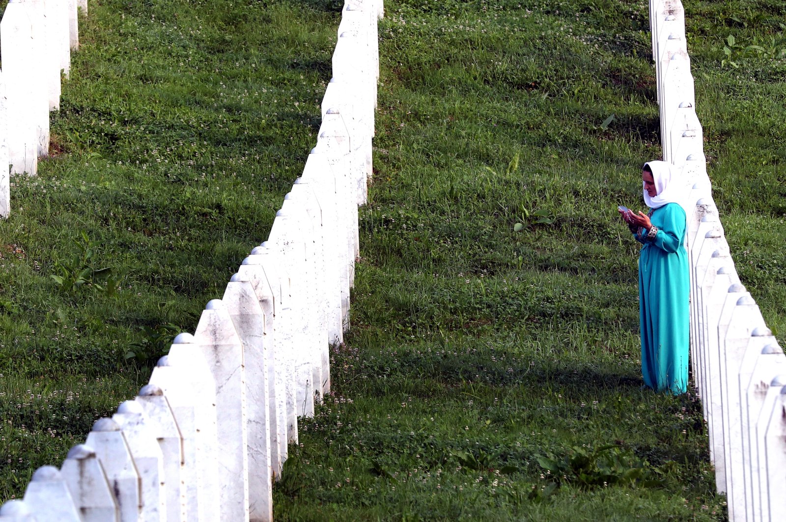 A Bosnian Muslim woman prays during a funeral ceremony for 30 newly-identified Bosnian Muslim victims, in Srebrenica, Bosnia and Herzegovina, July 11, 2023. (EPA Photo)