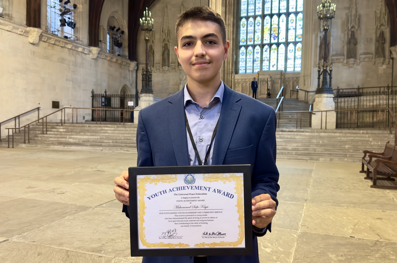 Sixteen-year-old Muhammed Safa Kaya poses with his award presented by the U.N.'s Universal Peace Federation (UPF) for outstanding leadership performance, Watford, U.K., July 12, 2023. (AA Photo)