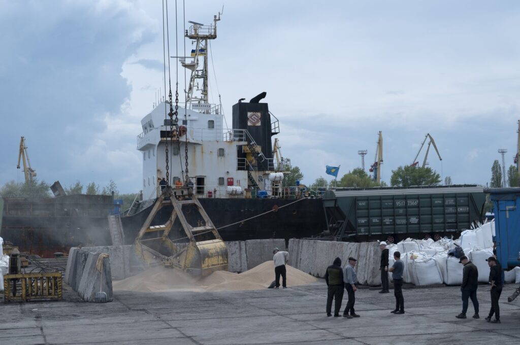 Workers load grain at a grain port in Izmail, Ukraine, April 26, 2023. (AP Photo)