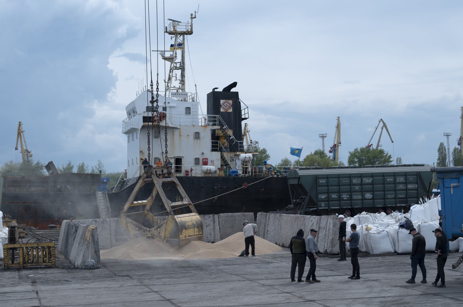 Workers load grain at a grain port in Izmail, Ukraine, April 26, 2023. (AP Photo)